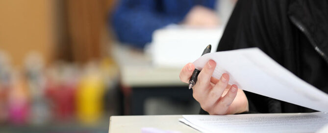 Australian student writing on an exam paper (Photo by Lincoln Beddoe/iStock)